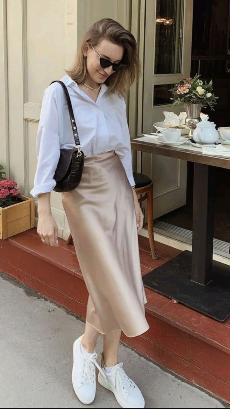 White button-down shirt with a beige silk midi skirt